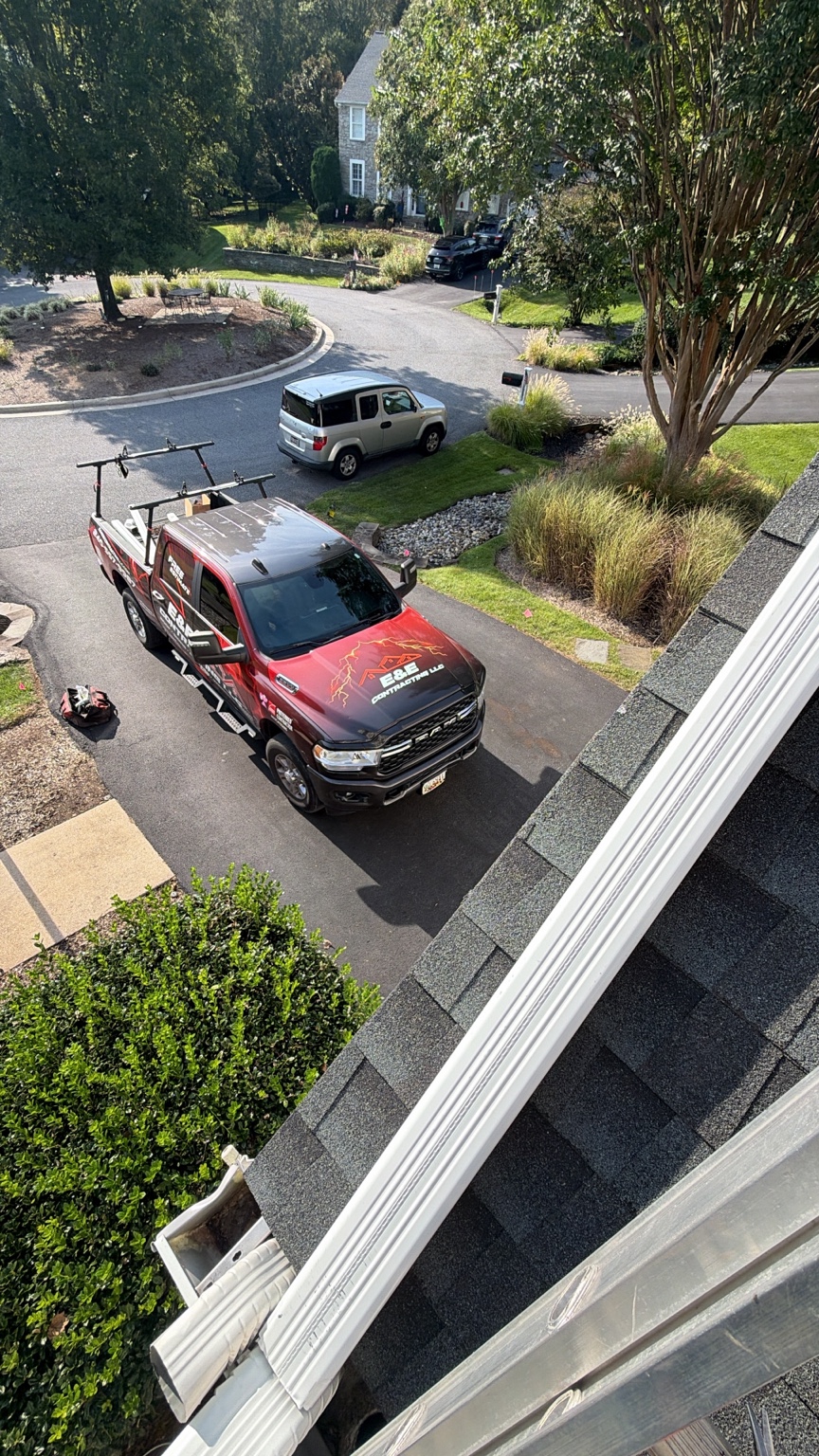 E&E branded roofing truck at a job site